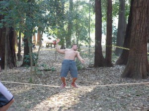A slack liner, the act of balancing on a line for moutain climbers, in Ibirapuera Park.