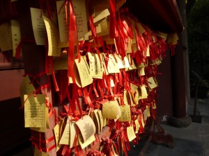 Prayer ribbons flap in the breeze at the Shanghai Confucian Temple. Asking for favor, there are three main important goals in Confucianism: 1. To get married 2. To meet a friend/acquaintance in an unusual place 3. To find your name on the passing list for government employment exams.     