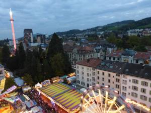 Typical carnival rides dot the landscape during a Swiss fair.